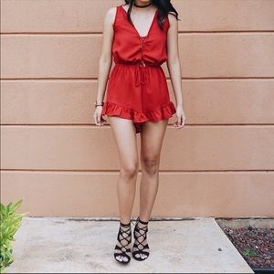 Red romper with ruffle bottom edge